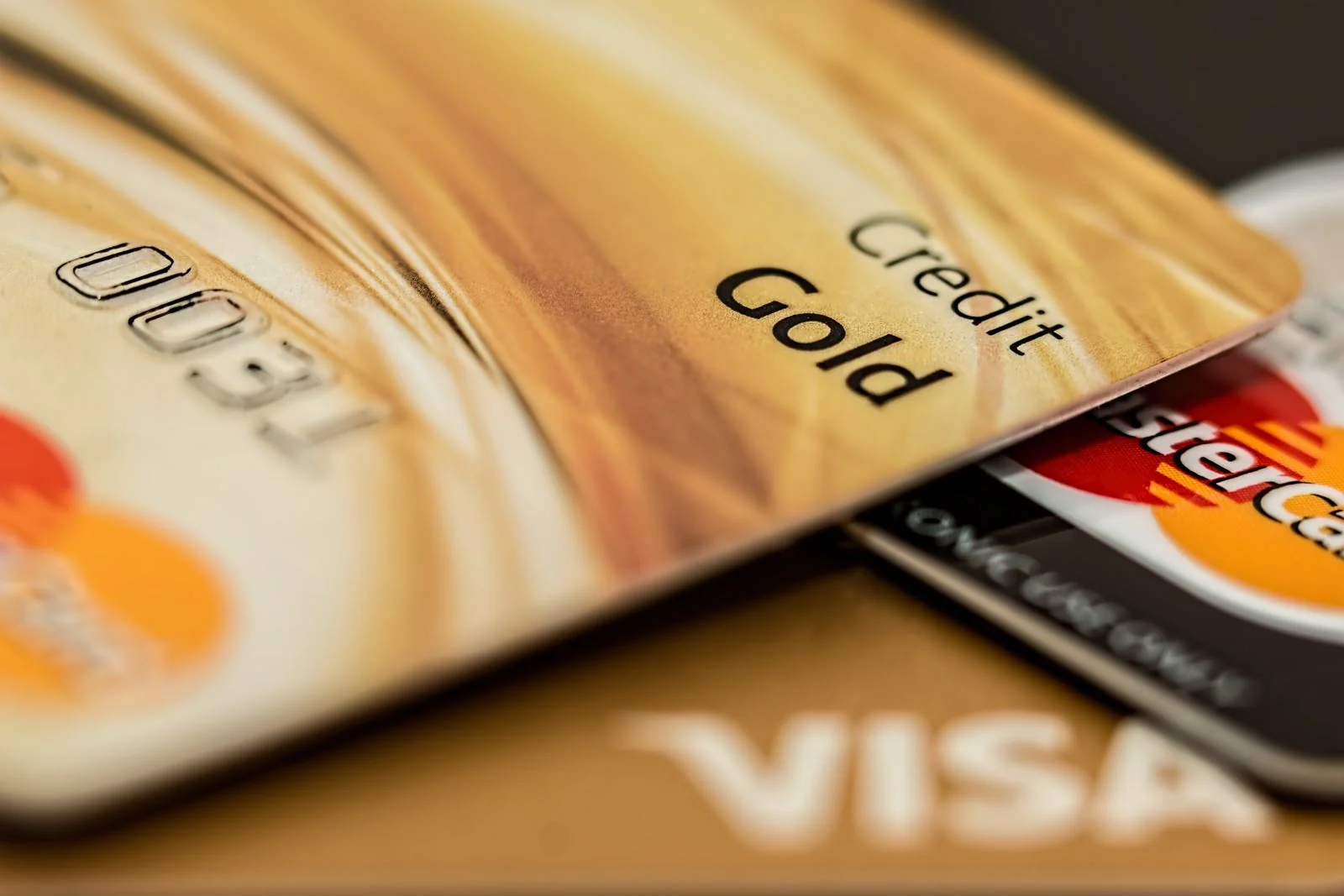 A stack of credit cards with Visa and Mastercard branding